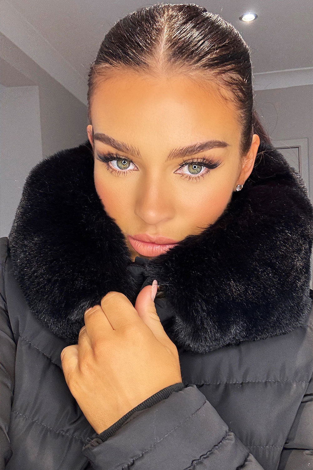 Black Puffer Jacket With Faux Fur Hood And Gold Belt